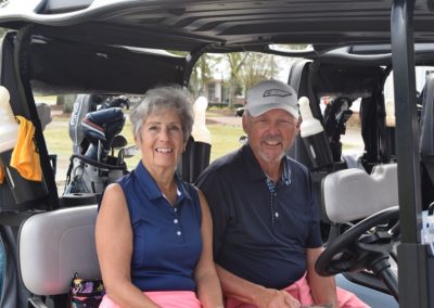 coastal alabama couples classic - couple on golf cart
